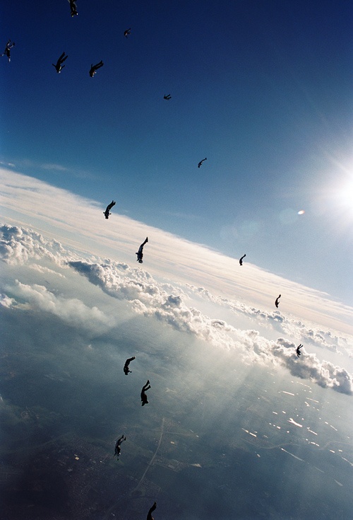 Aerial Skydiving Over Cloudy Landscape