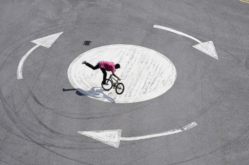 Bmx Cyclist Navigates Urban Circular Pattern