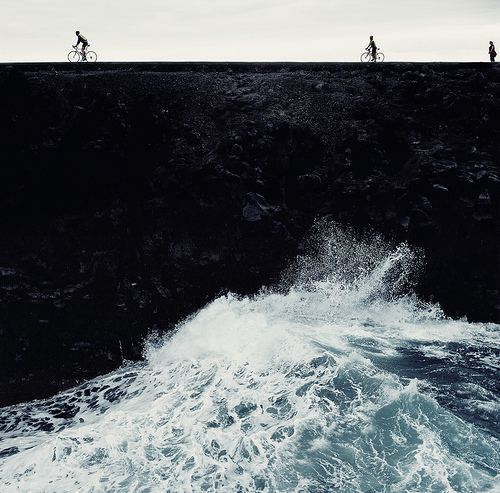 Cyclist Traversing Perilous Ocean Beam Landscape