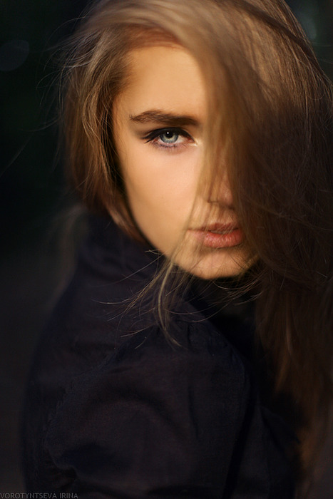 Portrait Of A Pensive Woman In Dimly Lit Room