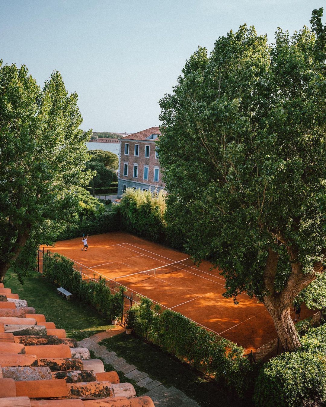 Vibrant Tennis Court In Verdant Venice Oasis