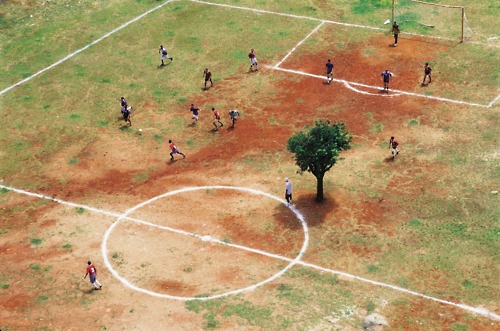 Children Playing In Courtyard Dusty Outdoor Scene