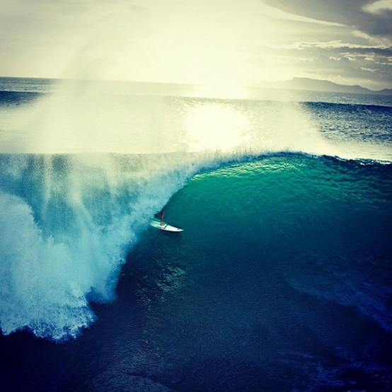 Surfer Riding Colossal Ocean Waves Landscape