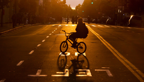 Bicycle Silhouette In Sunset City Street
