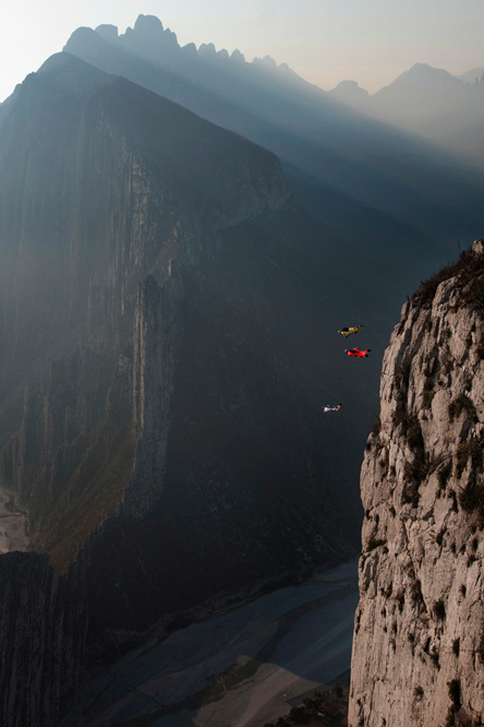 Rock Climbers Ascending Misty Mountain Peaks Aerial View