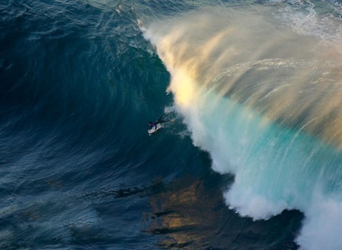 Surfer Riding Towering Ocean Wave Aerial View