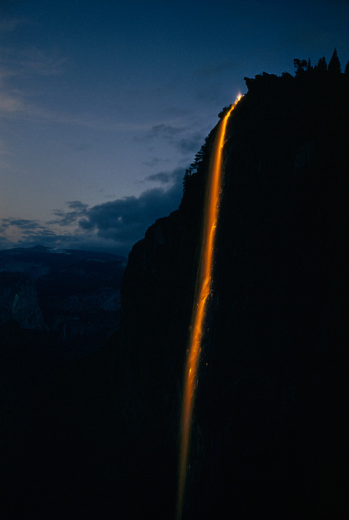 Cascading Waterfall Illuminated Cliffside Landscape