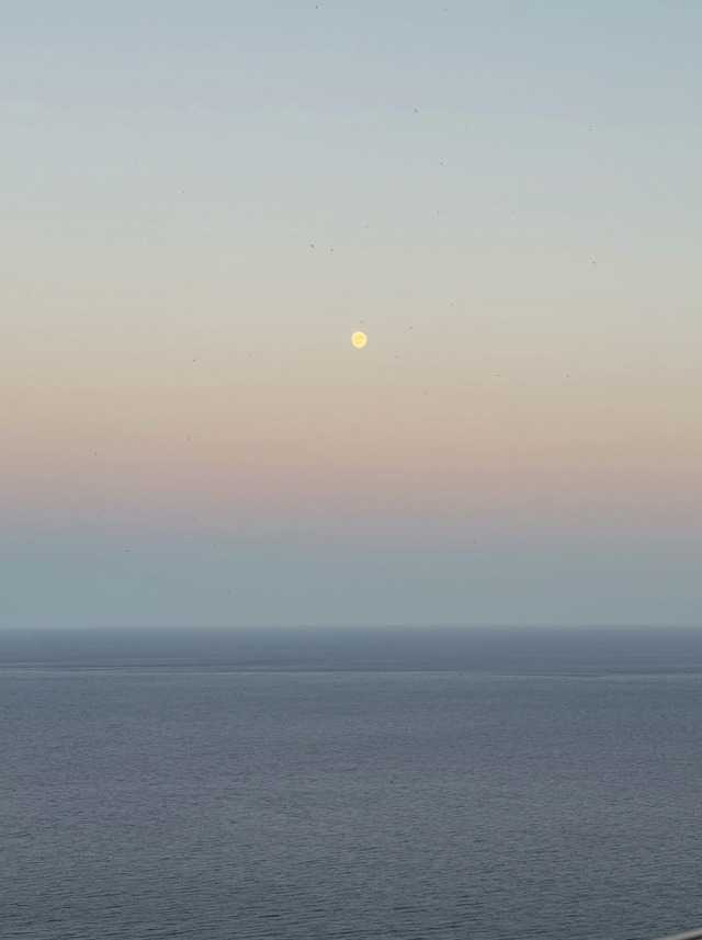 Moon Rising Over Calm Ocean