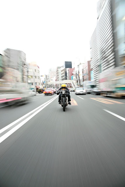 Motorcycle In Bustling City Street View