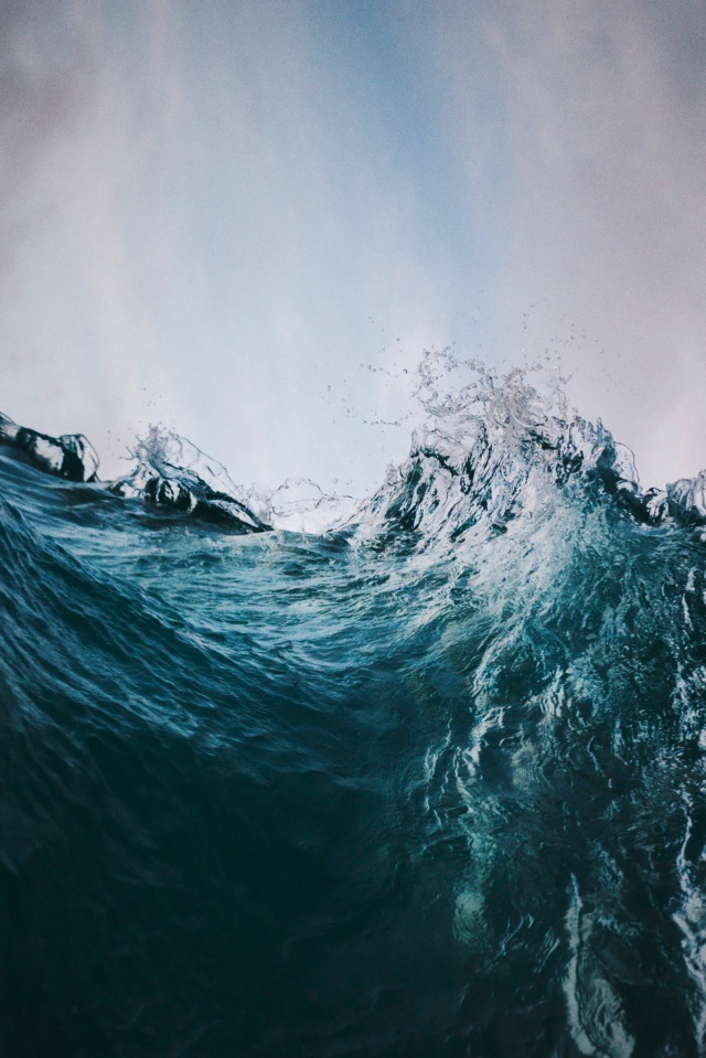 Ocean Waves Crashing Against Rocky Shore