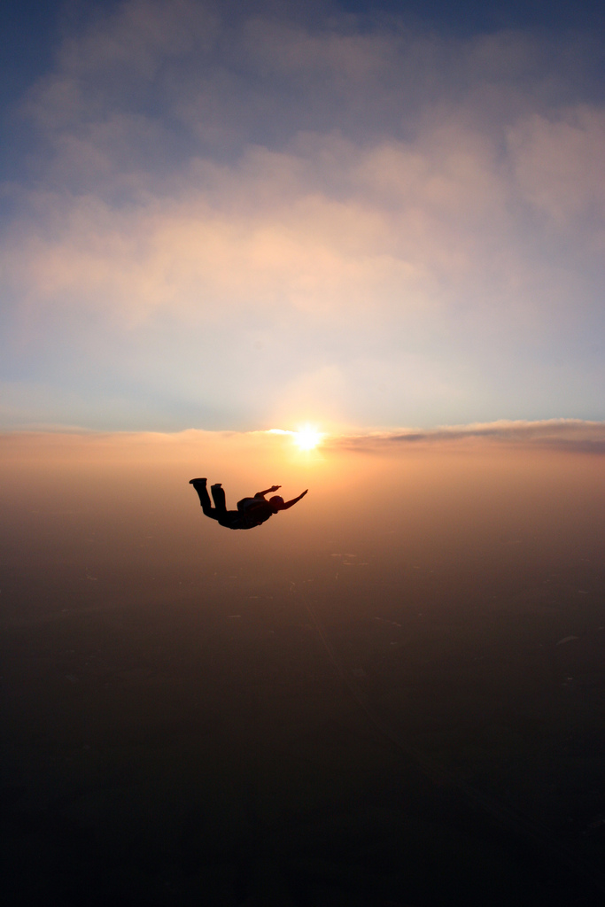 Skydiver Silhouette Over Sunset Sky