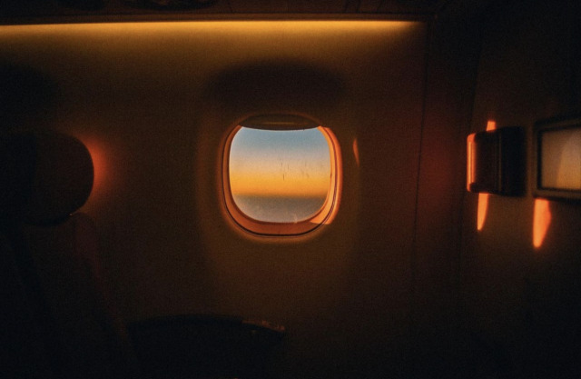 Aerial Sunset Landscape Through Airplane Window