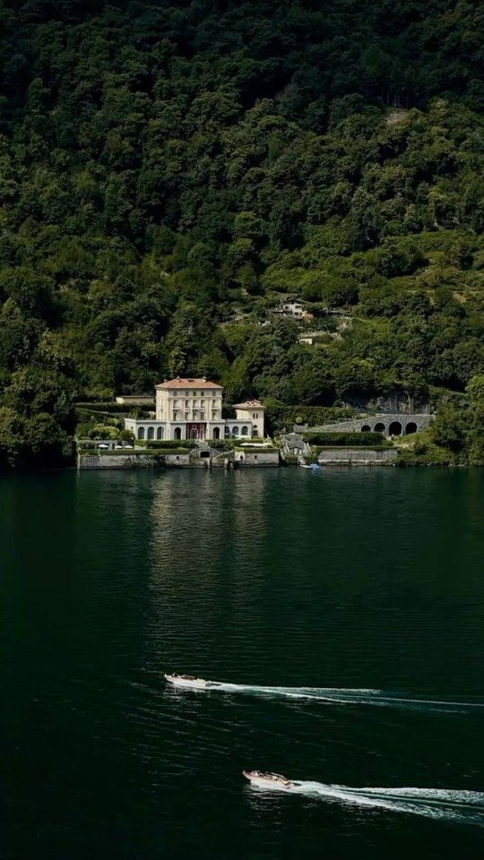 Pink Villa Lakefront Green Hillside Forest Boats Wake