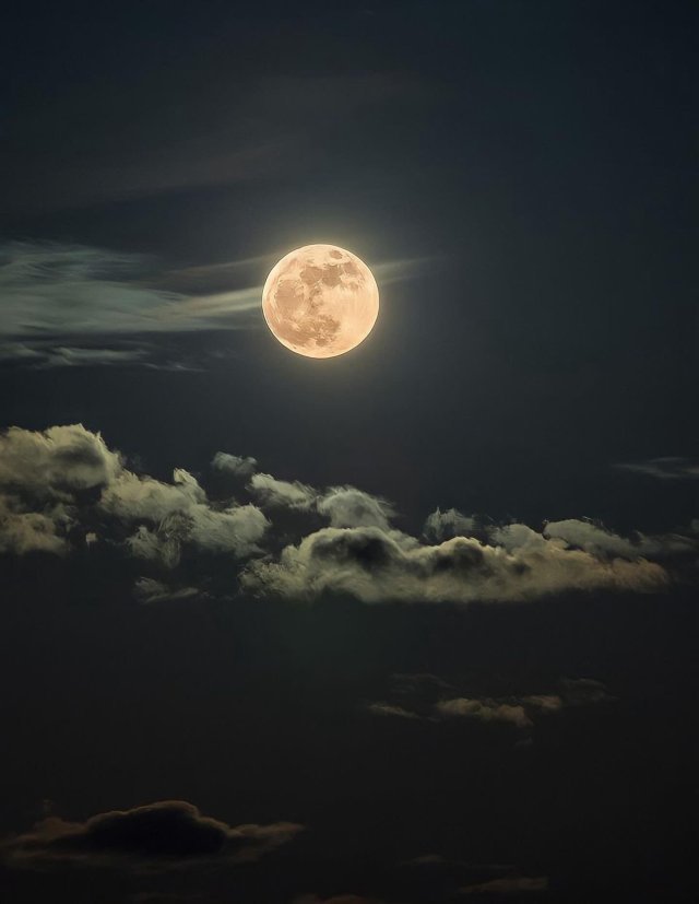 Full Moon Glowing Through Dark Clouds Night Sky