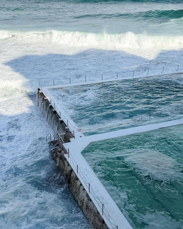 Ocean Pool White Fence Breaking Waves Turquoise Water