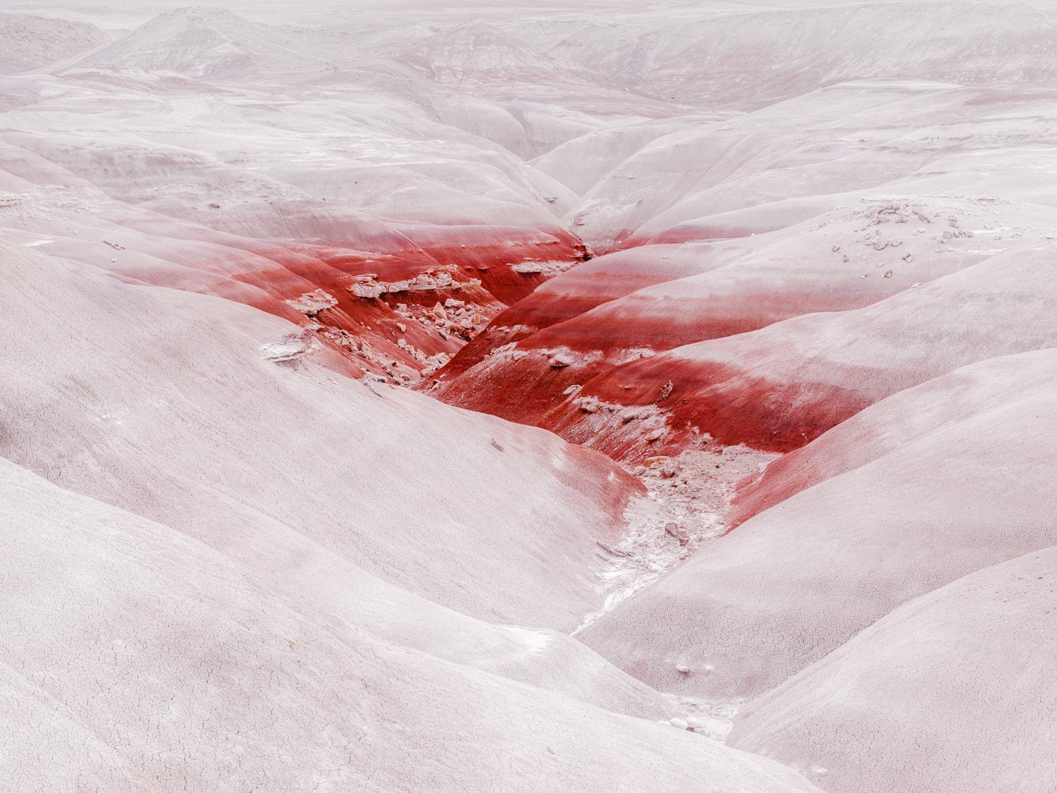 Red Mineral Deposits Snow Covered Mountain Valley Terrain