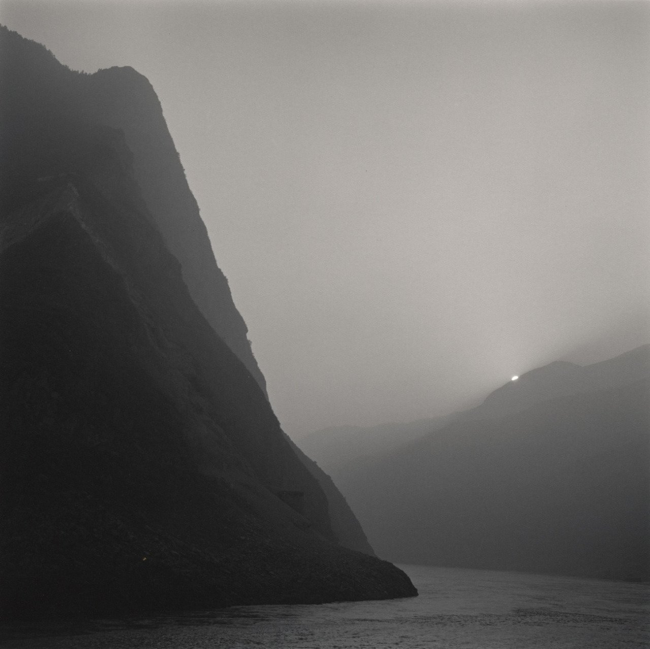 Steep Cliff Fjord Water Foggy Gray Mountains