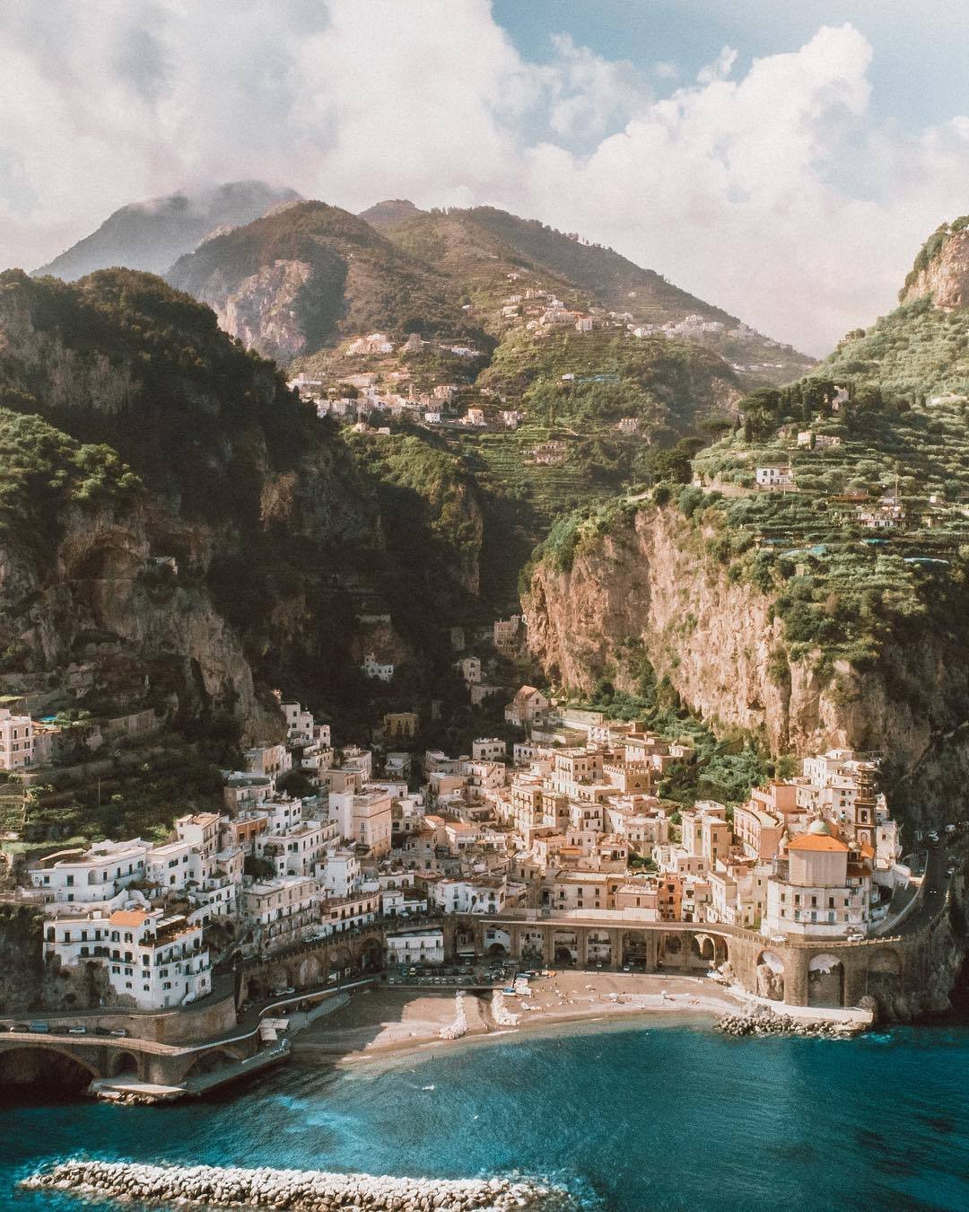 Coastal Village Terraced Buildings Cliffside Mountains Turquoise Water Beach