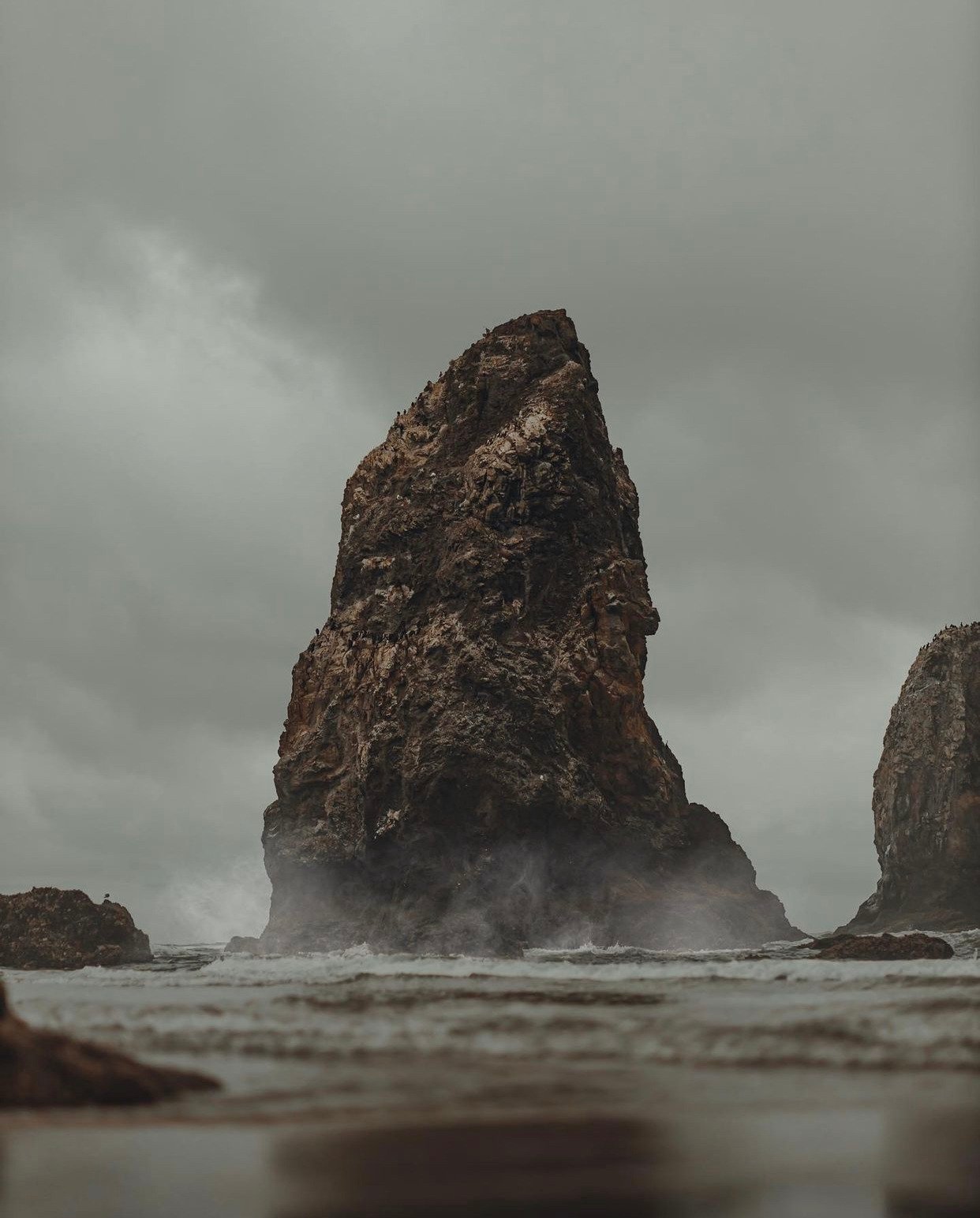 Tall Rock Formation Sea Stack Misty Ocean Waves