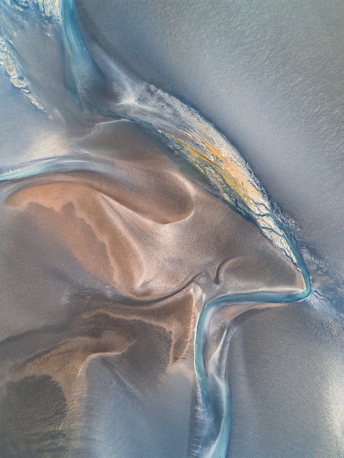 Aerial View Glacial River Ice Flowing Through Gray Sandy Terrain