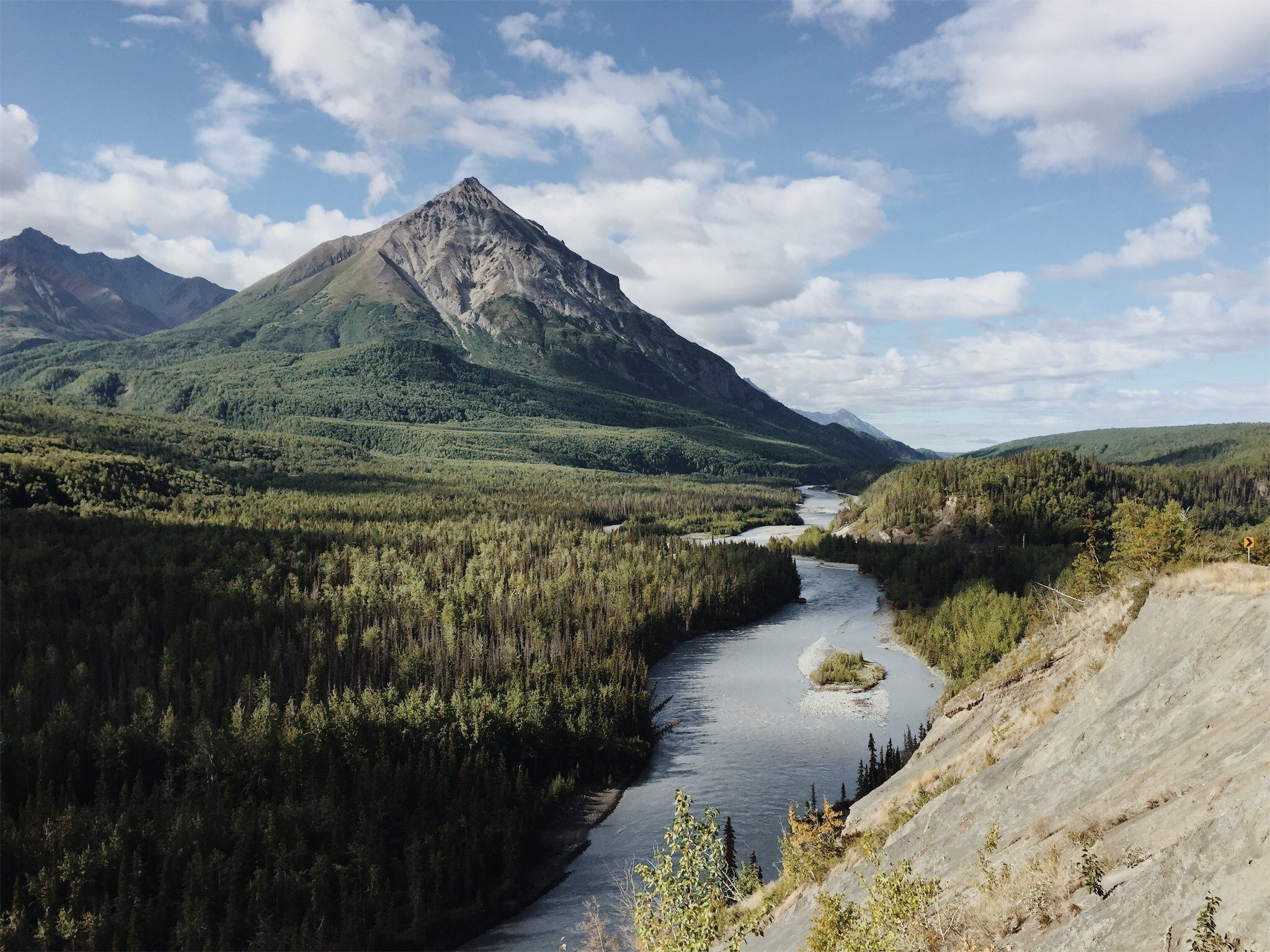 Winding River Through Green Forest Valley With Pyramid Peak Mountain