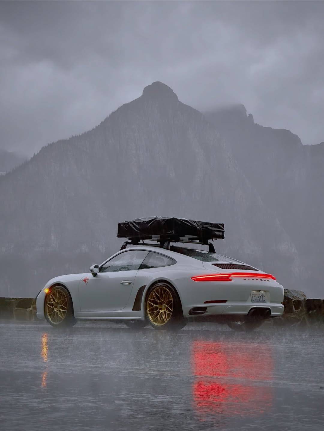 White Porsche 4S Roof Rack Rainy Mountain Landscape
